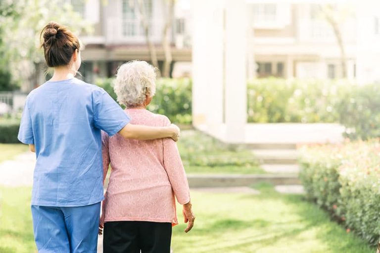 caregiver walking alzheimer's patient